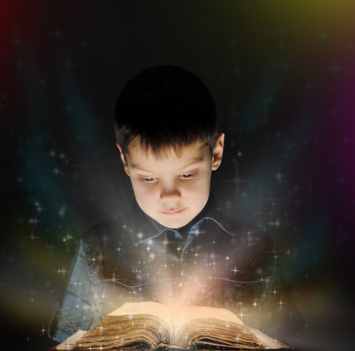 Boy reading magical book