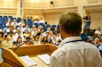 Man delivering a lecture; image courtesy of iStockphoto/Cimmerian