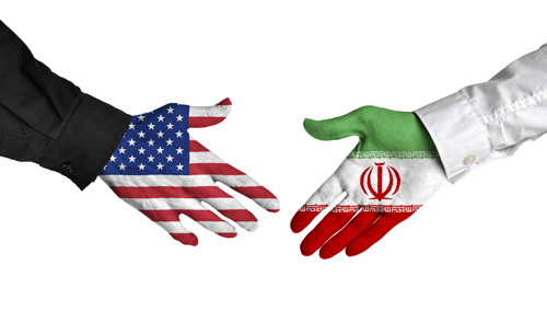 Two hands, one with the US flag painted on it, the other teh IRanian flg