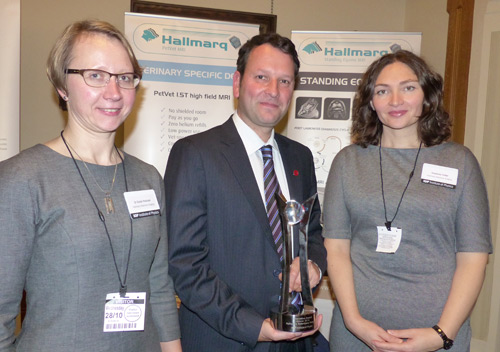 Photograph of three physicists, Giedre Podolyak, Steve Roberts and Snezhana Chater, holding their IOP Innovation Award