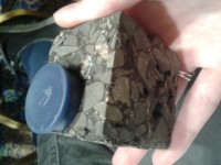 A sample of asphalt to which steel-wool fibres have been added, making the material magnetic