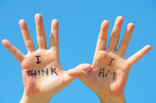 Hands with writing showing "I think" and "I am"