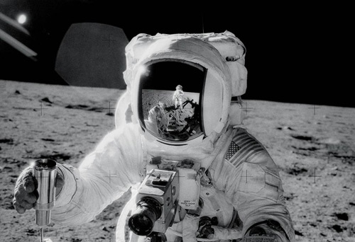 Photograph of astronaut Alan L Bean collecting some lunar soil on the Apollo 12 mission