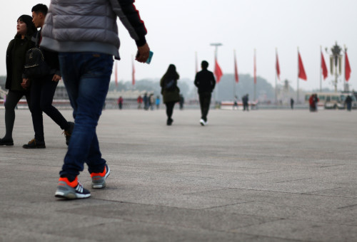 Photo of man walking through Tiananmen Square
